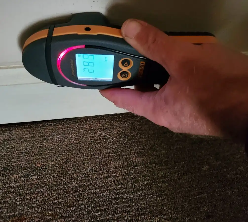 Moisture detection at baseboard during Storm Damage Restoration in Jennings